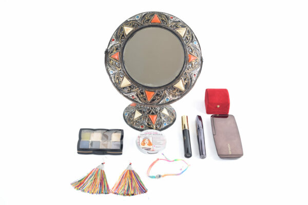 Moroccan vanity mirror with makeup on the table