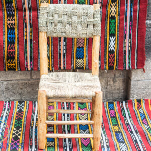 Moroccan straw chair on colorful rug