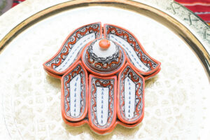 Red Hamsa dish with 7 pieces and bowl an example of decoration courtesy of Morocco.